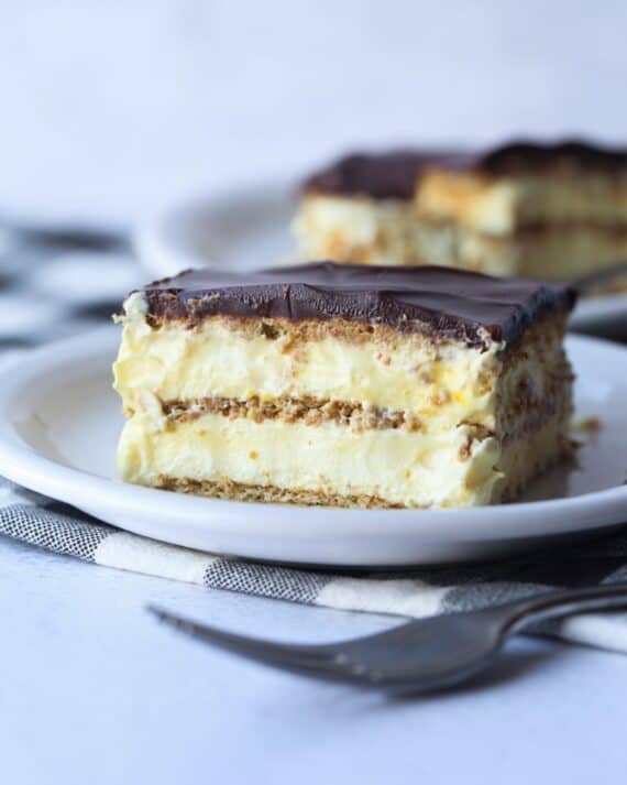 Eclair Cake on a plate with layers of vanilla pudding and graham crackers