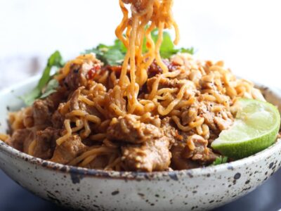 Pork Ramen Noodles in a bowl being eaten