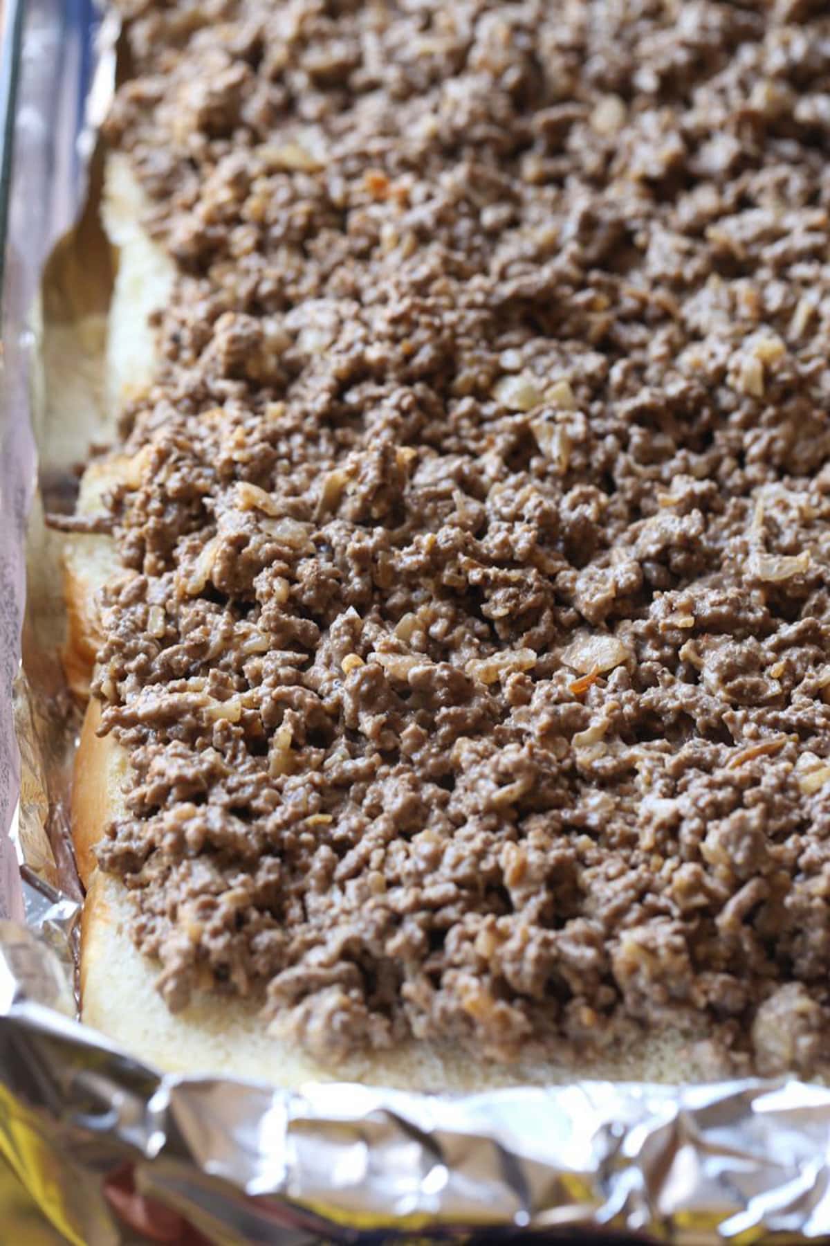 Ground beef is ready to have cheese placed on top.