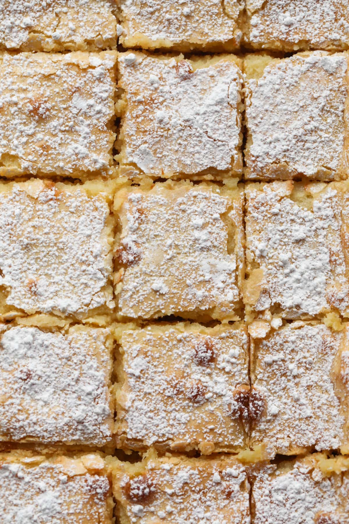 Ooey gooey butter bars cut into squares.