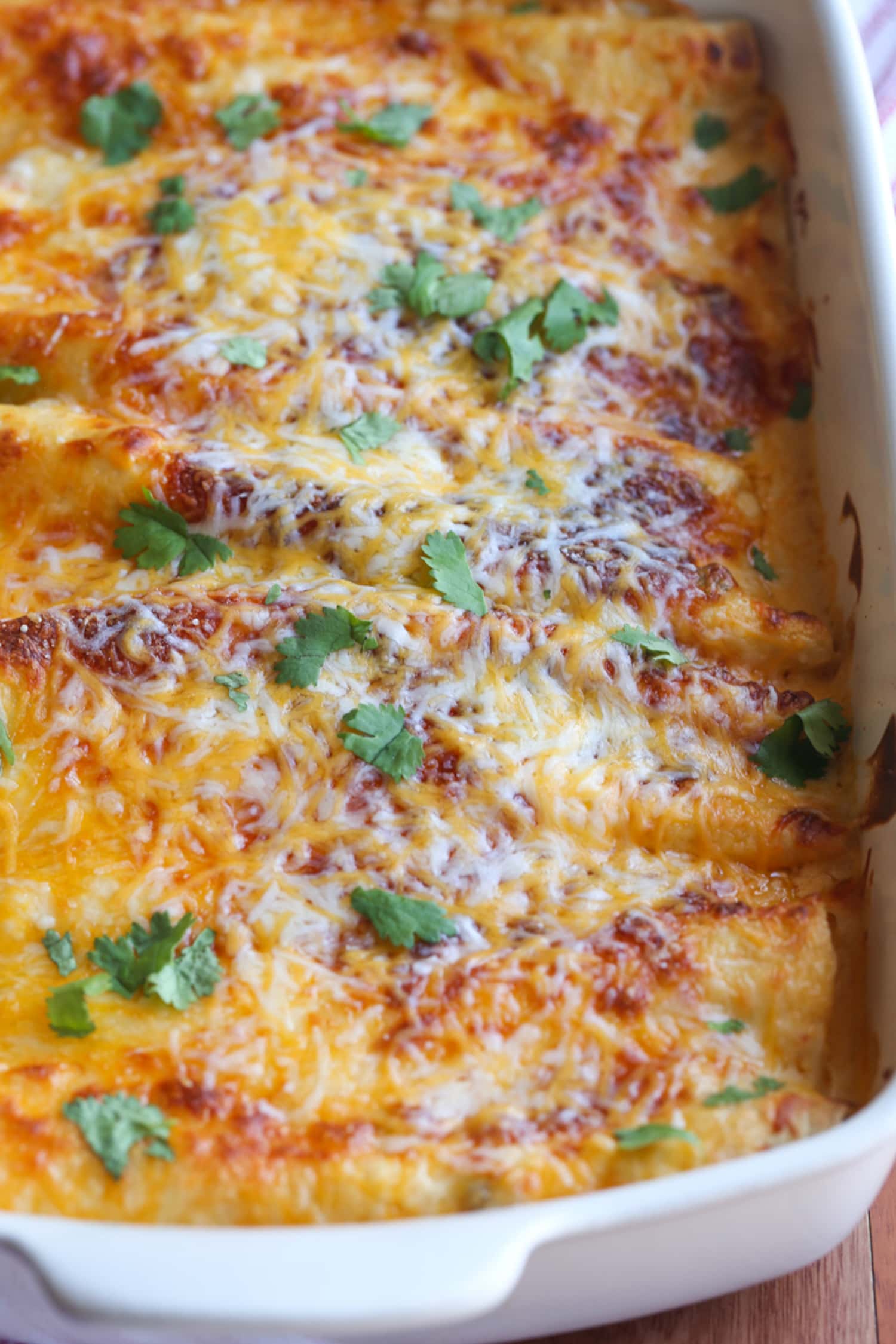 casserole dish with cheese covered enchiladas