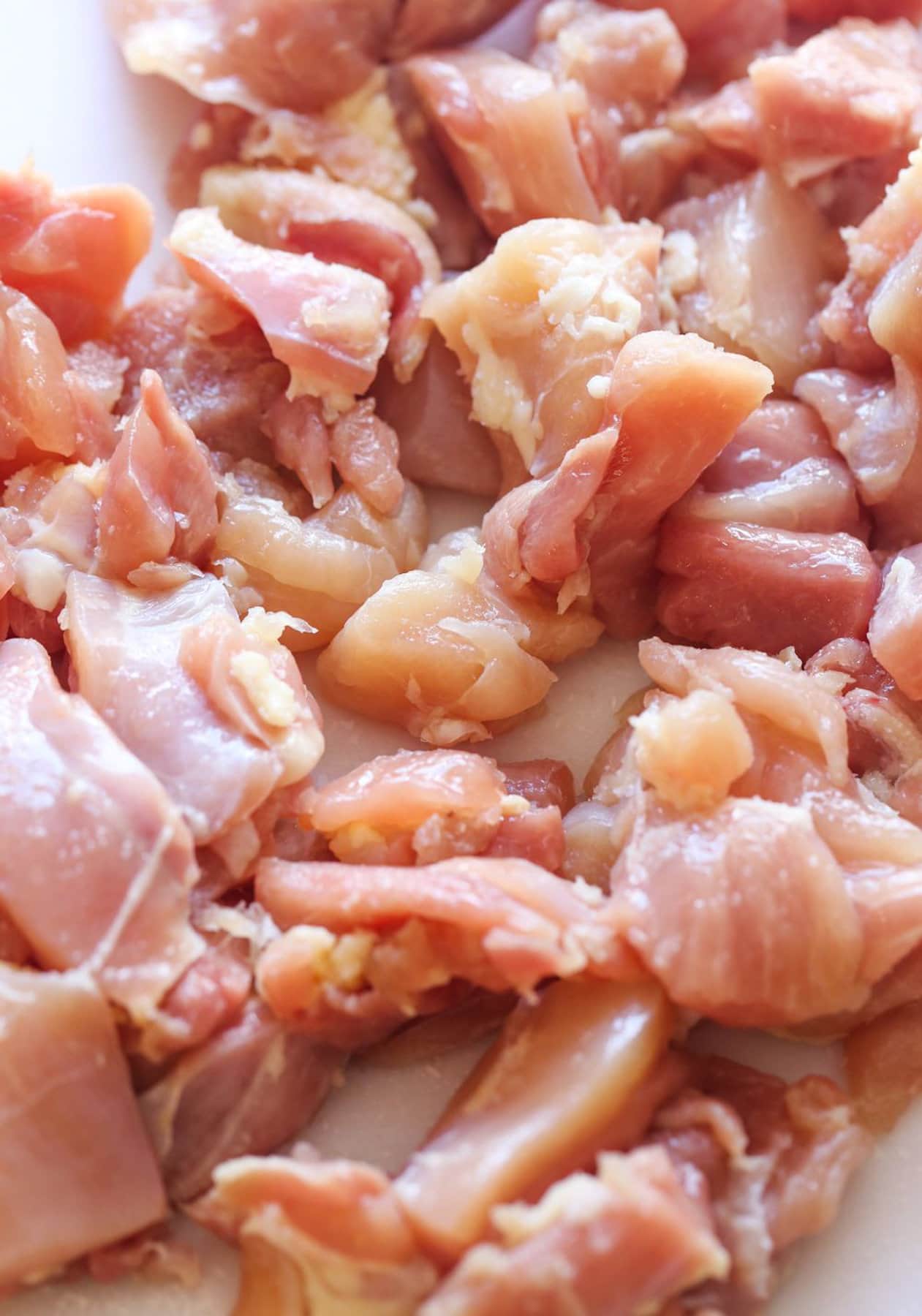 Raw diced chicken prepared to cook.