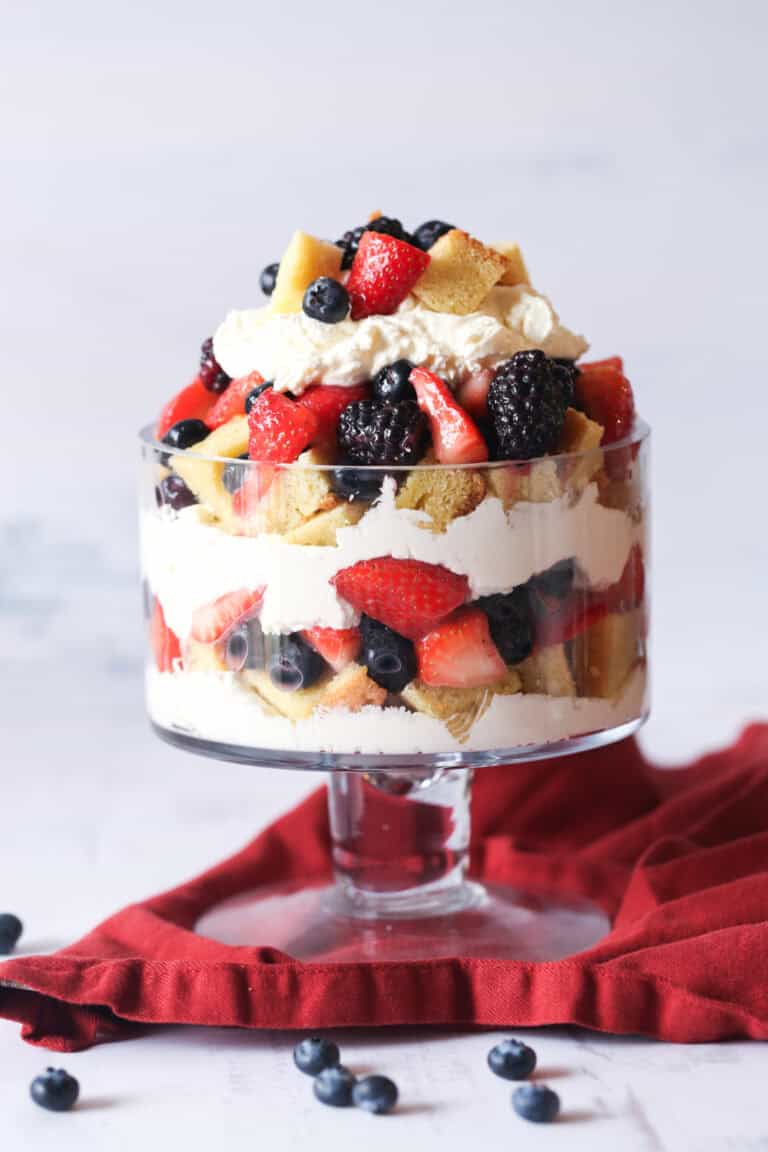 Berry pound cake trifle assembled in a glass pudding dish.