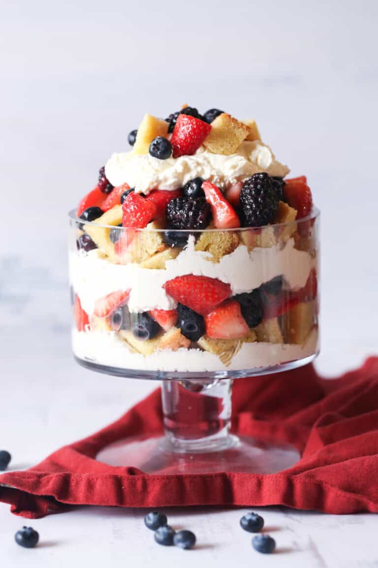 Triple berry pound cake is assembled in a triple glass dish.