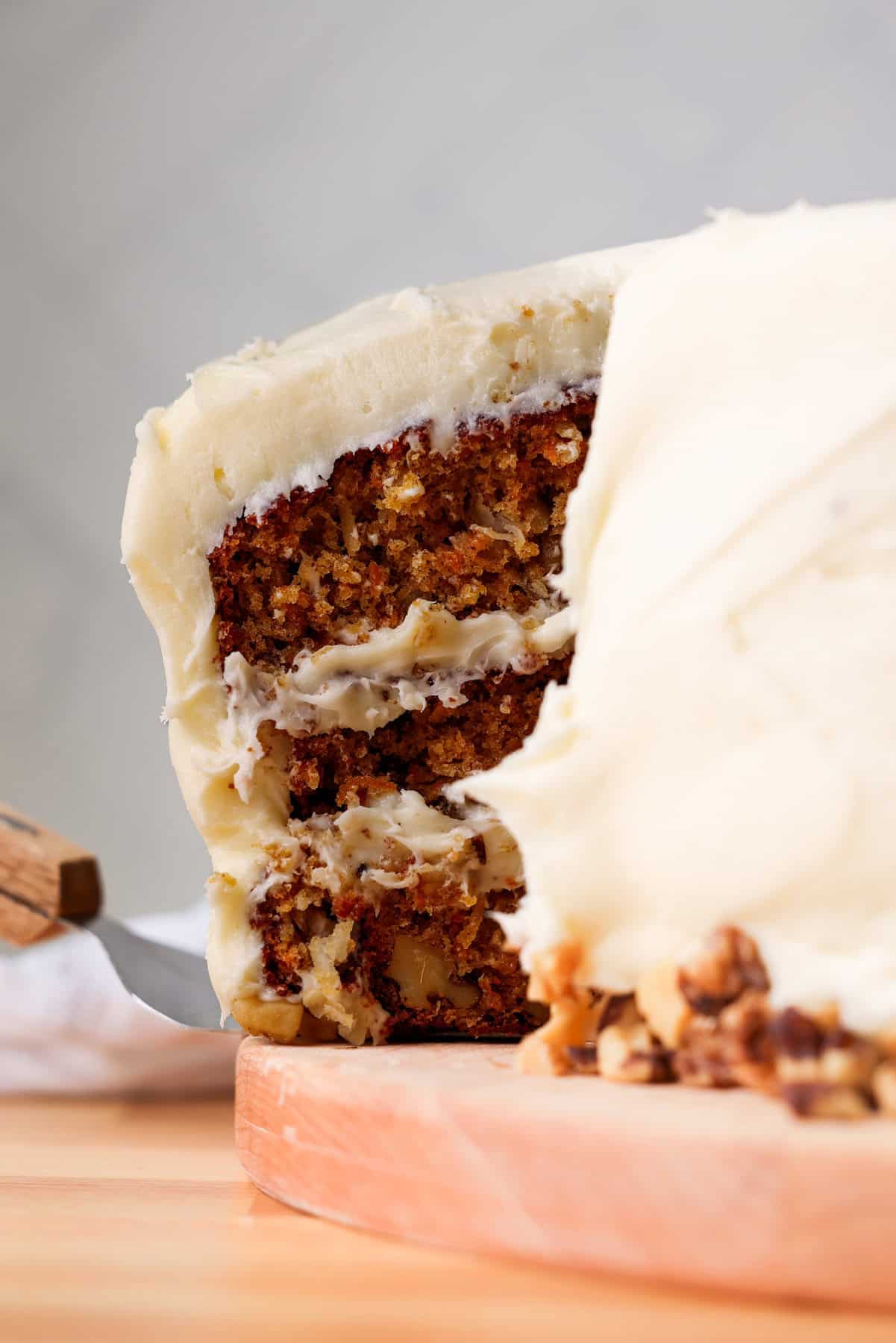 slicing a piece of carrot cake and serving with a spatula