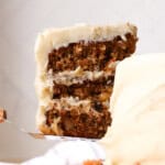 lifting a piece of carrot cake off of a cake plate