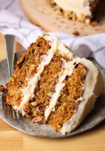 a slice of carrot cake on a plate with a fork