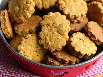 A dog bowl filled to the brim with homemade dog treats.