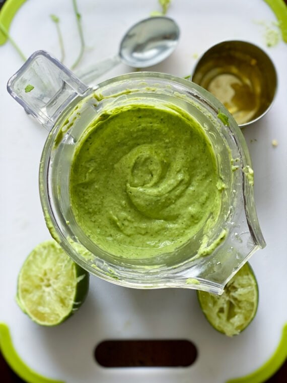 Blender with avocado salsa inside after blending