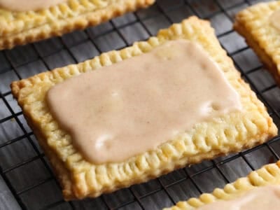 Homemade Pop Tarts covered with icing and cooling on a wire rack