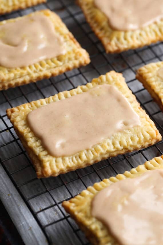 Homemade Pop Tarts covered with icing and cooling on a wire rack