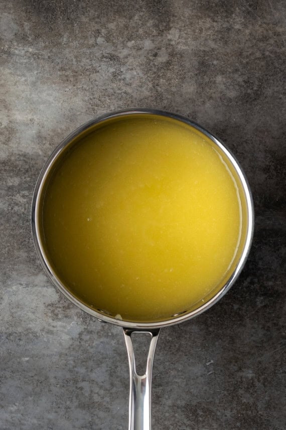 Combine sugar with melted butter in a saucepan.