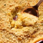 Close up of a spoon scooping corn casserole