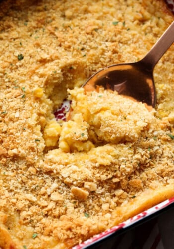 Close up of a spoon scooping corn casserole