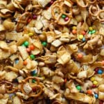 Frito Snack mix on a baking sheet with M&Ms, Fritos, pretzels, and chex cereal