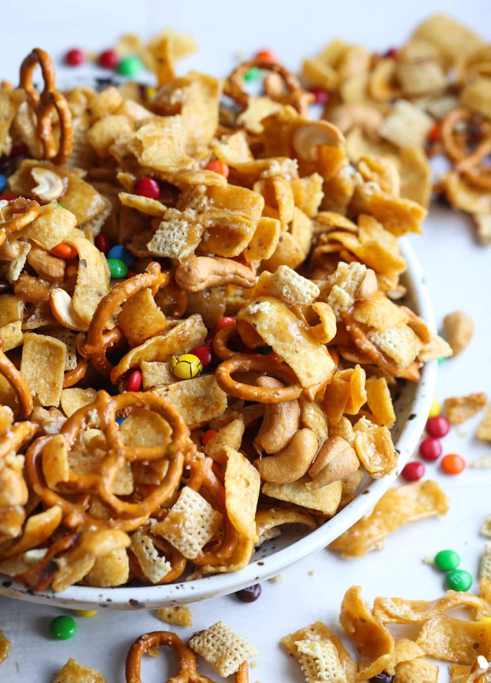Salty sweet snack mix in a bowl with pretzels, chex and Fritos.