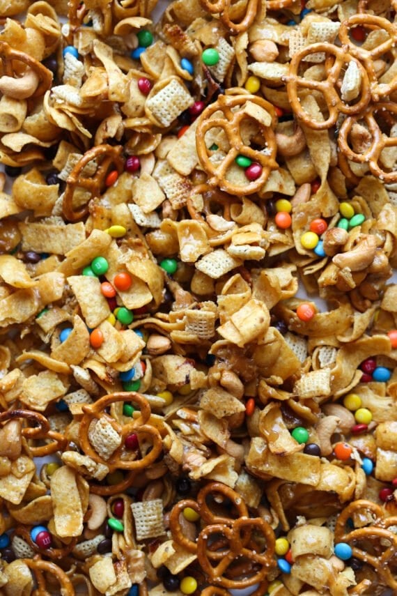 Frito Snack mix on a baking sheet with M&Ms, Fritos, pretzels, and chex cereal