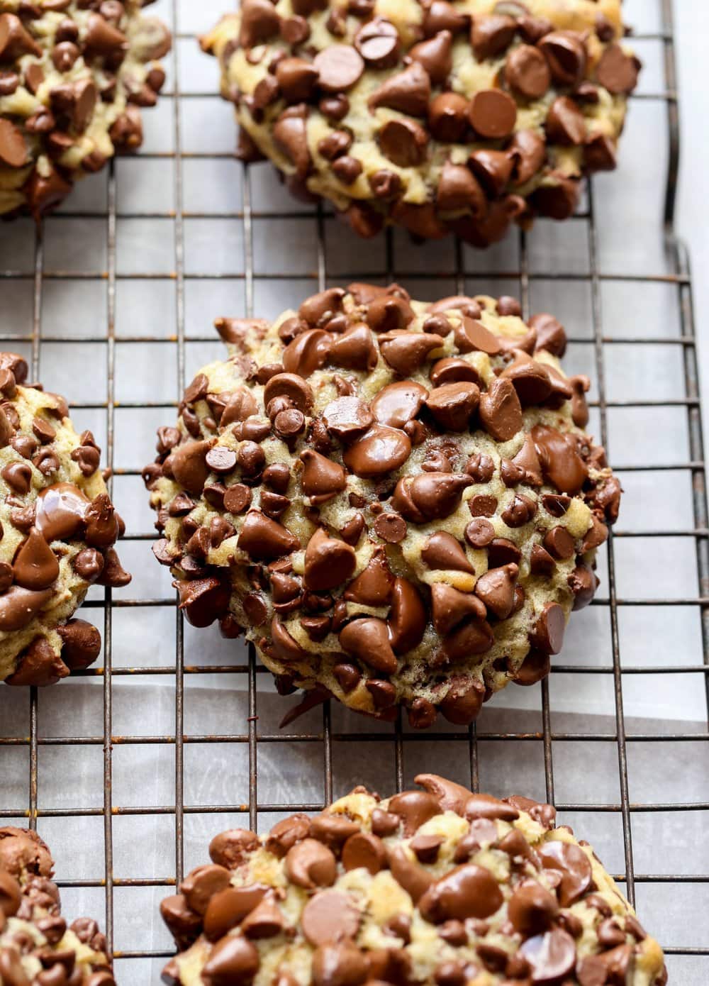 cookie covered in chocolate chips on a cooling rack