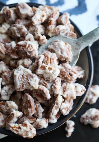 Sour Cream Candied Pecans in a bowl with a spoon to scoop