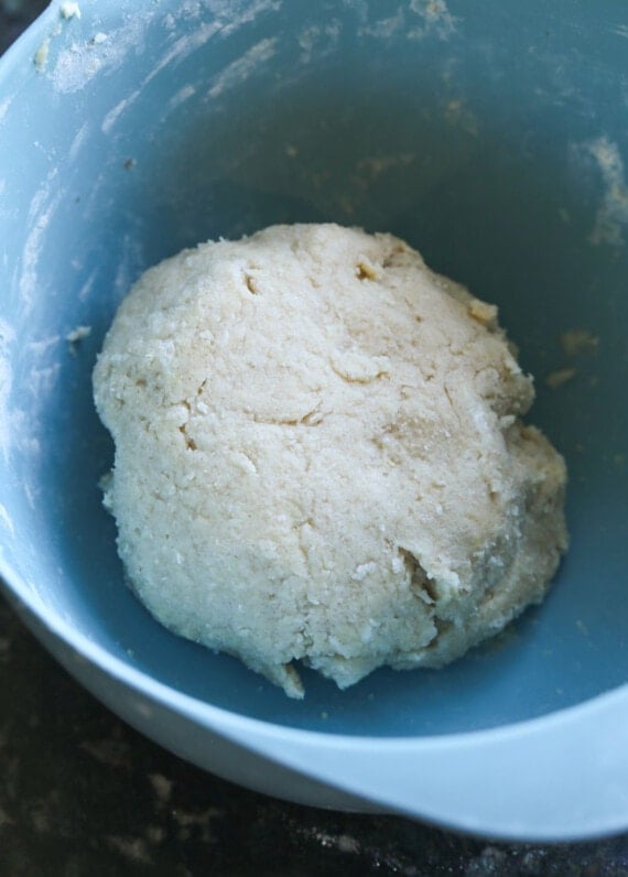 Dough formed into a ball inside a bowl