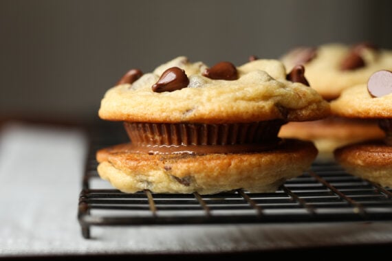 two chocolate chip cookies with melted peanut butter cup in the middle