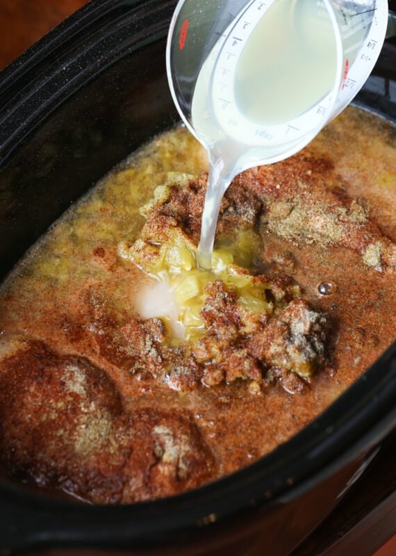 Pouring margarita mix into a slow cooker