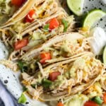 Beergarita chicken tacos on a plate with toppings