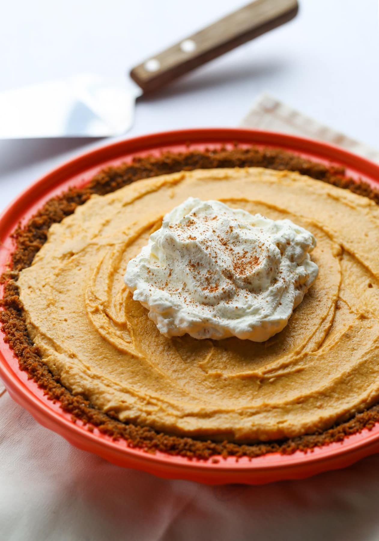 Fluffy Pumpkin Mousse Pie topped with a cinnamon dust