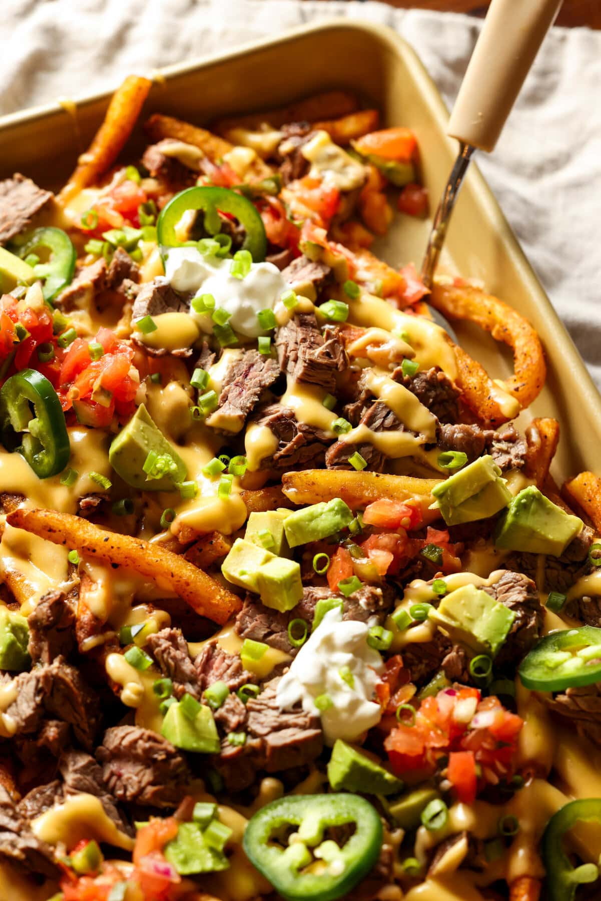 French fries topped with Carne Asada, cheese, avocado, and sour cream