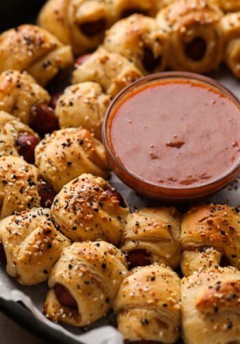 Pigs In a Blanket topped with everything seasoning and dipping sauce