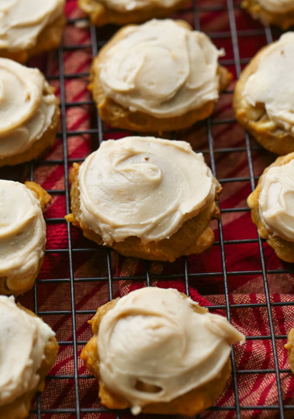Pumpkin Cookies with brown sugar icing on top on a wire cooking rack