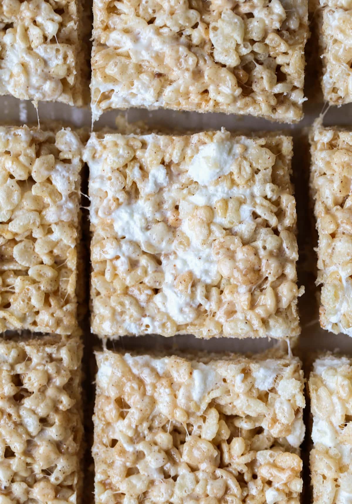 Pumpkin Spice Rice Krispie Treats cut into squares on a cutting gboard from above.