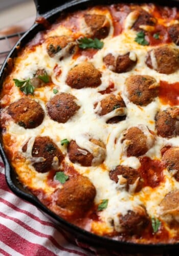 Chicken Parm meatballs in a cast iron skillet