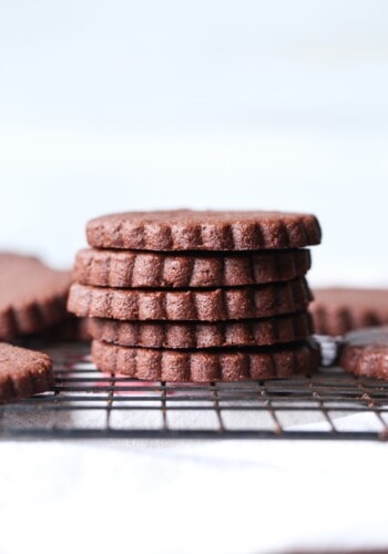 A Pile of Five Chocolate Sugar Cookies Sitting on a Cooling Rack