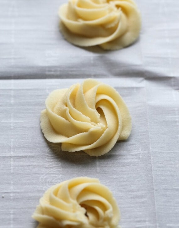 Swirled butter cookie dough on a baking sheet with parchment paper