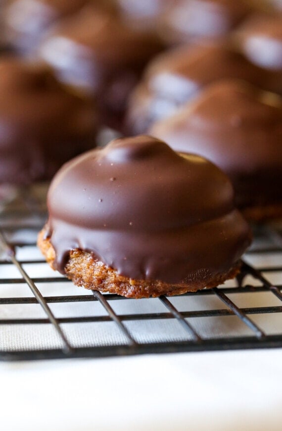 Graham cookie dipped in melted chocolate on a cooling rack