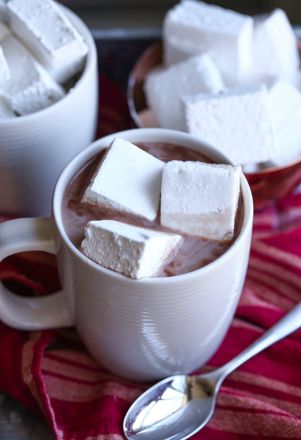 Three Homemade Marshmallows Floating in a Mug of Hot Chocolate