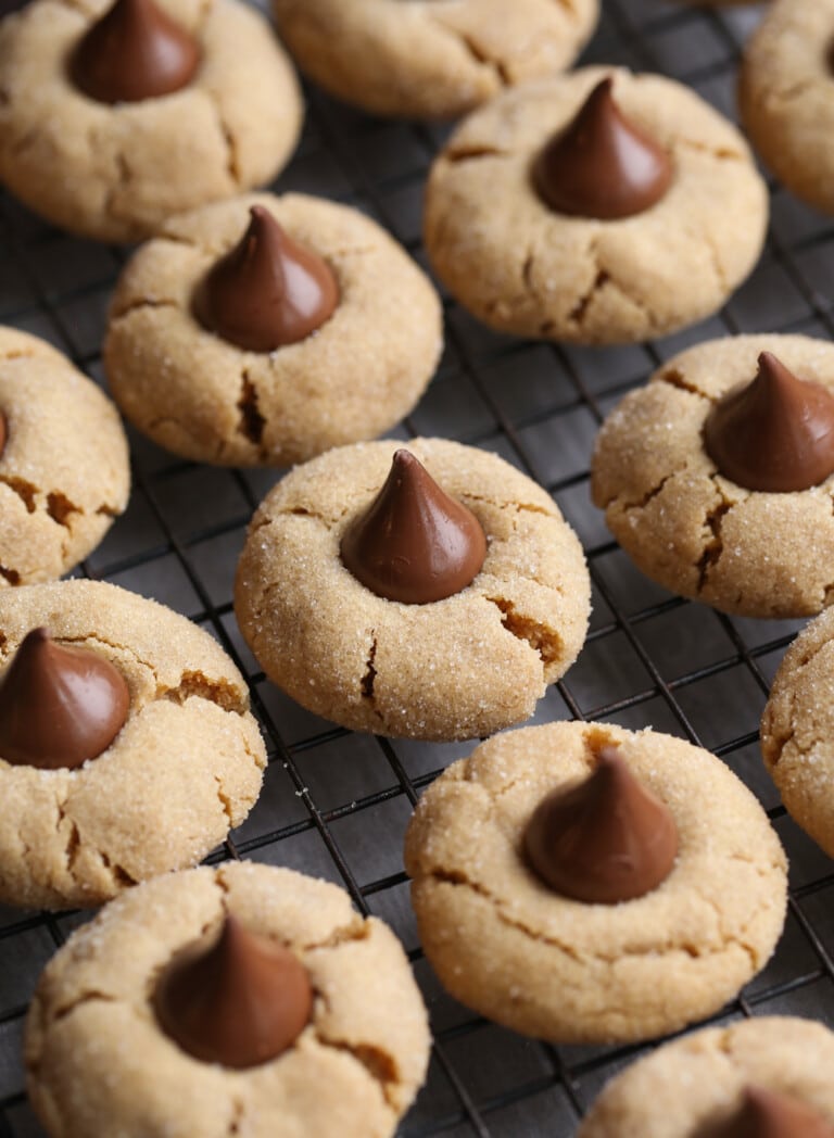 Peanut Butter Blossom Cookies lined up in rows on a wire rack.