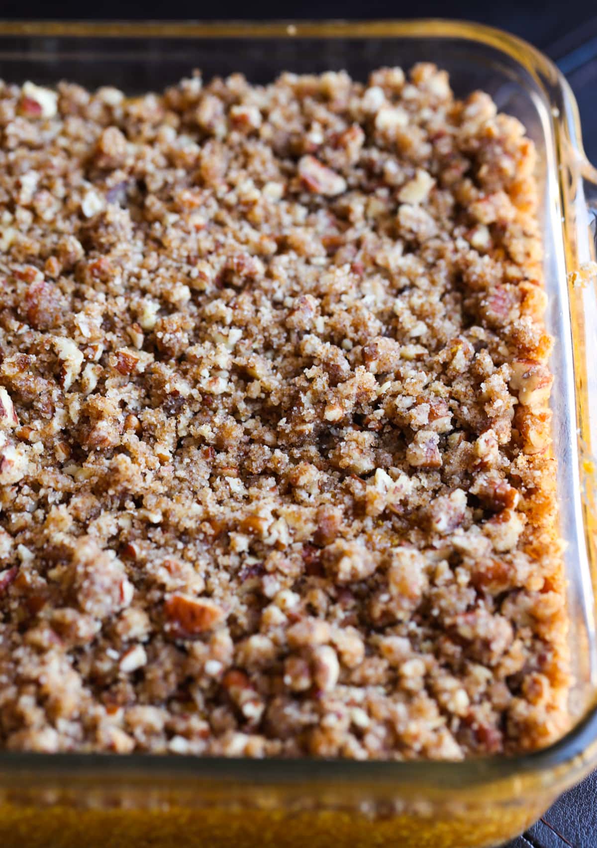Unbaked sweet potato puree with a pecan streusel in a baking dish.