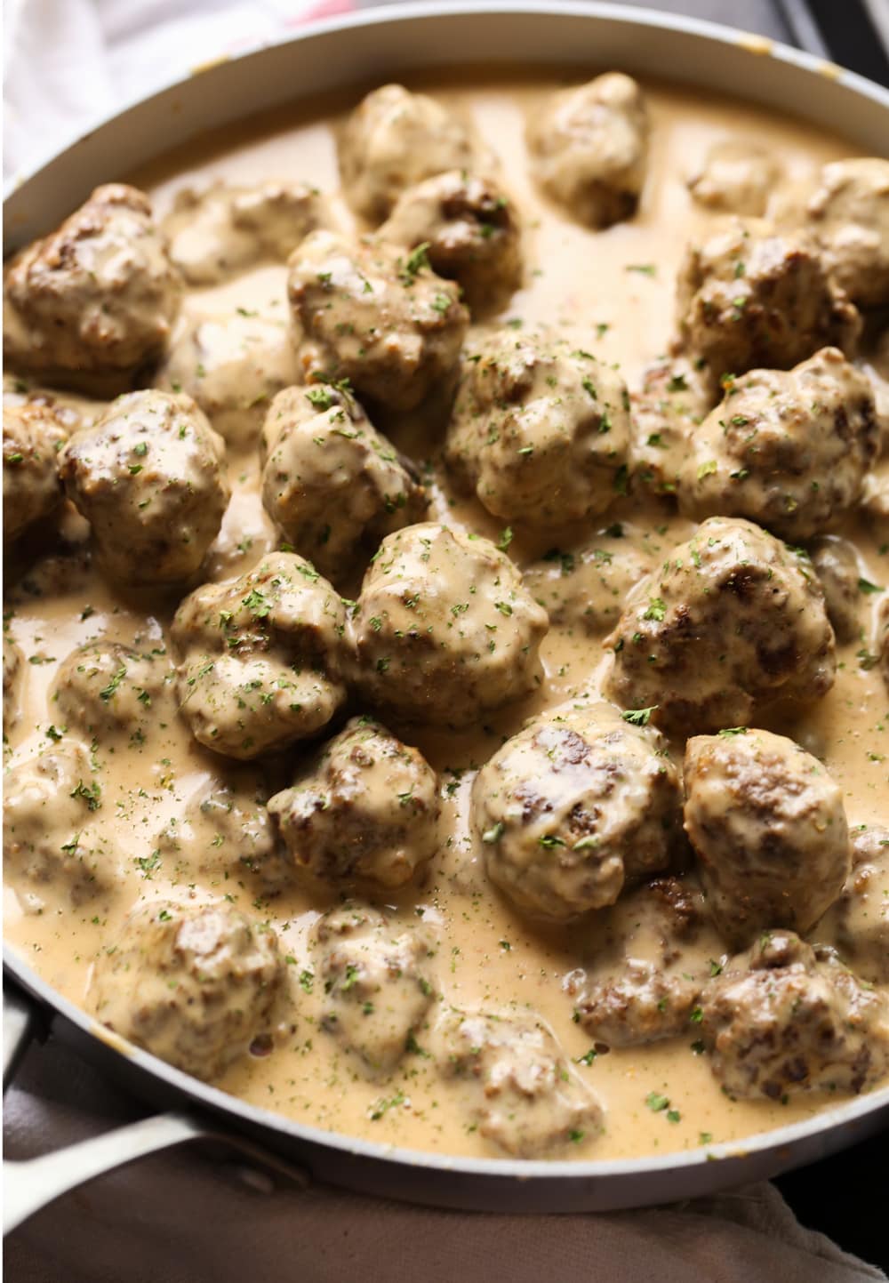 Swedish meatballs with gravy in a pan.