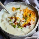Creamy potato soup covered with bacon and cheese