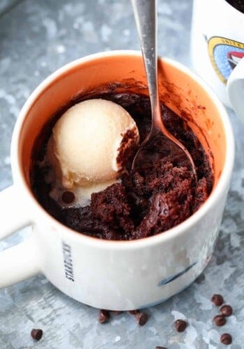 Cooked brownie in a mug topped with ice cream