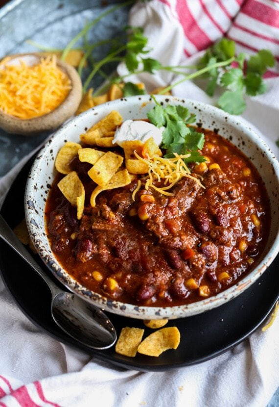 Chili topped with Fritos, cilantro, and sour cream