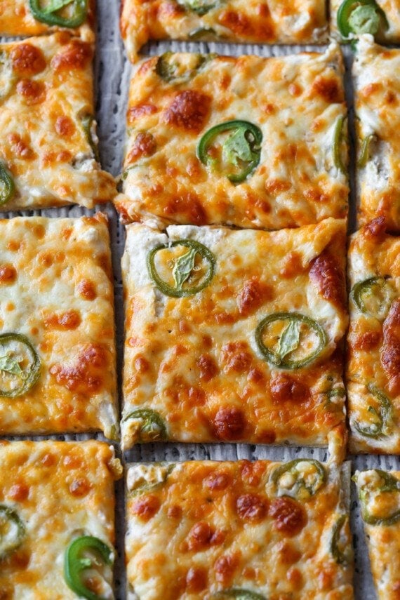 Jalapeno Popper Pizza sliced on a tray