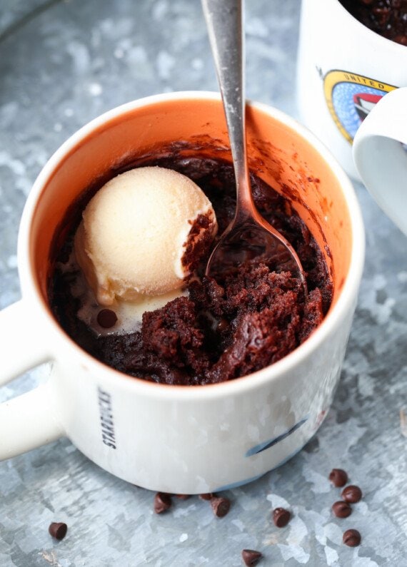 Cooked brownie in a mug topped with ice cream