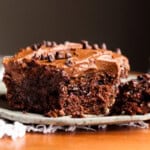 Poke Cake topped with chocolate frosting with a fork