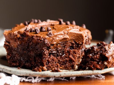 Poke Cake topped with chocolate frosting with a fork