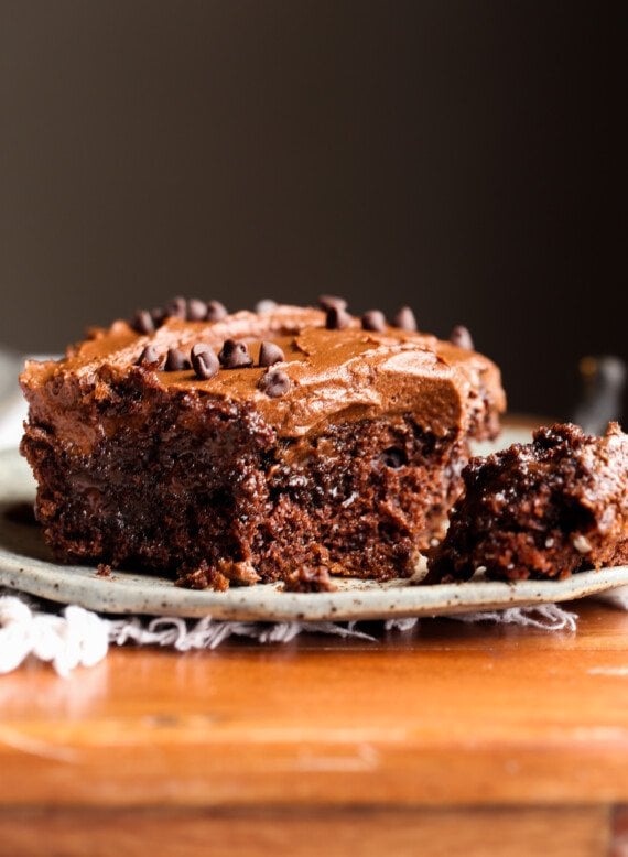 Poke Cake topped with chocolate frosting with a fork