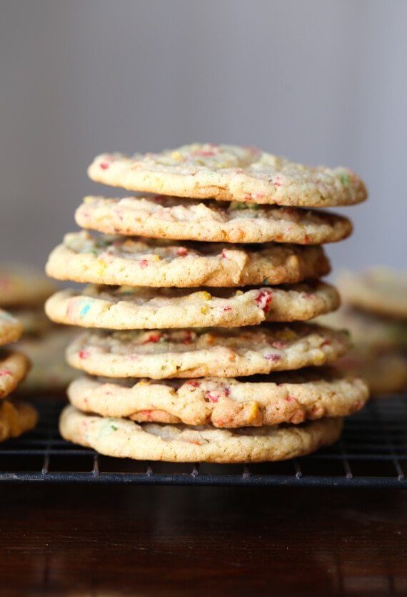 Stacked Fruity Pebbles Sugar Cookies on a wire rack