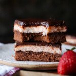 Strawberry Brownies stacked on a plate with a bite taken out